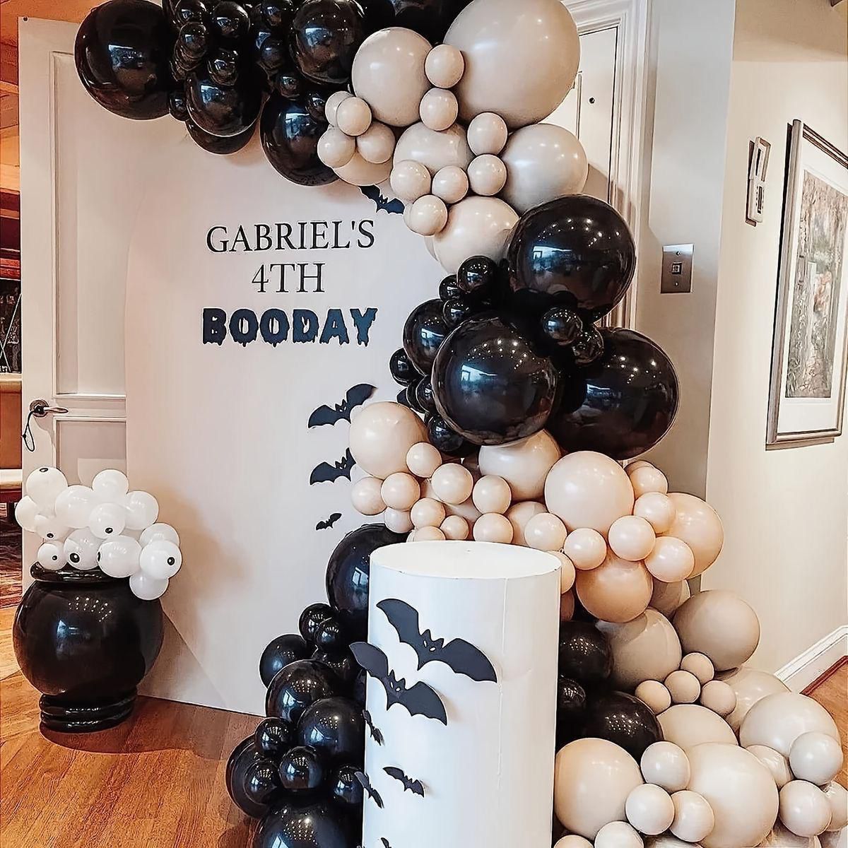Black and cream birthday balloon setup with custom sign