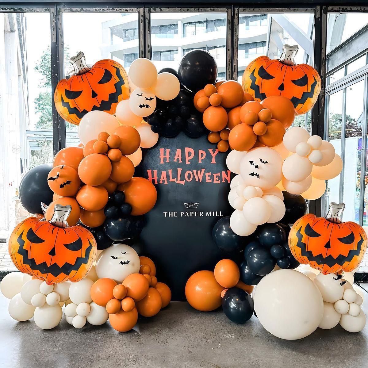 Halloween balloon arch with pumpkins for party setup